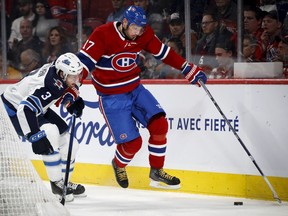 Montreal Canadiens left wing Ilya Kovalchuk battles for the puck with Winnipeg Jets defenseman Tucker Poolman during NHL action in Montreal, on Monday, January 6, 2020.