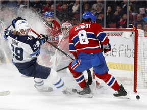 Montreal Canadiens defenceman Ben Chiarot prevents Winnipeg Jets right wing Patrik Laine from getting to the puck as Montreal Canadiens goaltender Carey Price looks on during NHL action in Montreal, on Monday, January 6, 2020.