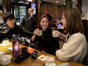 Justine Belzile, left to right, Gaëlle Goulet-Bourdon and Valérie Charland share laughs and drinks at the Burgundy Lion in Montreal on Wednesday, Jan. 8, 2020.