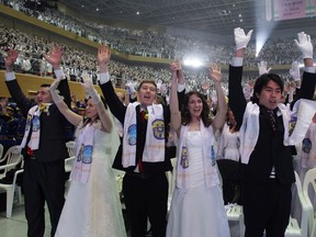 Couples take part in a mass wedding of the Family Federation for World Peace and Unification, commonly known as the Unification Church, at Cheongshim Peace World Center on March 3, 2015, in Gapyeong-gun, South Korea.