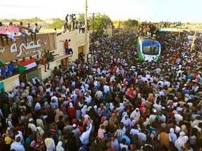 Sudanese protesters cheer upon arriving from the capital of Khartoum to the town of Atbara on December 19, 2019 to celebrate the first anniversary of the uprising that toppled Omar al-Bashir and to demand justice for slain protesters.