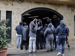 Journalists gather at the entrance of the underground parking of a house said to belong to former Nissan chief Carlos Ghosn in a wealthy neighbourhood of the Lebanese capital Beirut on January 4, 2020.