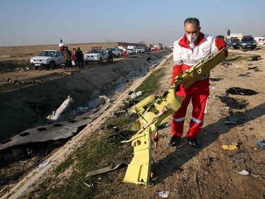 Rescue teams recover debris from a field after a Ukrainian plane carrying 176 passengers crashed near Imam Khomeini airport in the Iranian capital Tehran early in the morning on January 8, 2020, killing everyone on board.