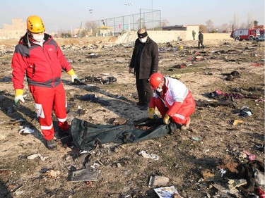 Rescue teams recover a body after a Ukrainian plane carrying 176 passengers crashed near Imam Khomeini airport in the Iranian capital Tehran early in the morning on January 8, 2020, killing everyone on board. - The Boeing 737 had left Tehran's international airport bound for Kiev, semi-official news agency ISNA said, adding that 10 ambulances were sent to the crash site.