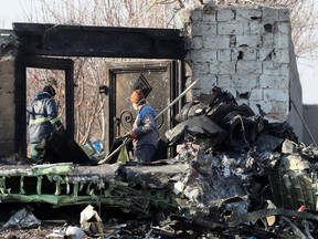 Rescue teams work amidst debris after a Ukrainian plane carrying 176 passengers crashed near Imam Khomeini airport in the Iranian capital Tehran early in the morning on January 8, 2020, killing everyone on board.