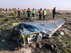 In this file photo taken on January 8, 2020 rescue teams are seen at the scene of a Ukrainian airliner that crashed shortly after take-off near Imam Khomeini airport in the Iranian capital Tehran.