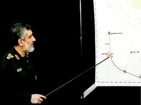 An image grab from Iranian State TV IRINN on January 11, 2020, shows Brigadier General Amir Ali Hajizadeh, aerospace commander of Iran's Revolutionary Guards, pointing at a map during a televised press conference in the capital Tehran. Hajizadeh said the missile operator acted independently when he shot down the Boeing 737 after mistaking it for a "cruise missile".