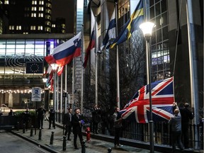 Staff members take down the United Kingdom's flag from the European Parliament building in Brussels on Brexit Day, January 31, 2020. - Britain leaves the European Union at 2300 GMT on January 31, 2020.