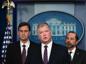 U.S. Deputy Secretary of State Stephen Biegun, centre, speaks, flanked by Secretary of Health and Human Services Alex Azar, right, during a briefing with members of the president's Coronavirus Task Force in Washington, D.C., on Friday, Jan. 31, 2020. The has issued a rare federal quarantine order of 14 days for 195 Americans who were evacuated from the Chinese city at the centre of a deadly global virus epidemic.