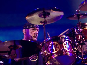 In Montreal in 2012, Neil Peart of Rush performs at the Bell Centre. The drummer and author died Jan. 7, 2020.