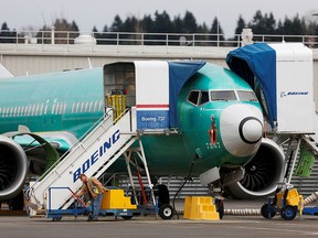 In this Dec. 16, 2019, file photo, an employee works near a Boeing 737 Max aircraft at Boeing's 737 Max production facility in Renton, Wash.