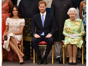 Britain's Queen Elizabeth, Prince Harry and Meghan, the Duchess of Sussex, pose for a picture at in London, Britain June 26, 2018.