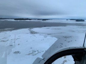 A scene from January 2020, when a helicopter carrying Sûreté du Québec officers searched an area for five missing French snowmobilers off Beemer Island near Lac-St-Jean Jan. 22, 2020. Three bodies were found and now, possibly, a fourth.