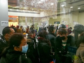 People queue for receiving treatment at the fever outpatient department at the Wuhan Tongji Hospital in Wuhan, Hubei province, China January 22, 2020. Picture taken January 22, 2020.