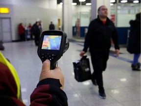 Kazakh sanitary-epidemiological service worker uses a thermal scanner to detect travellers from China who may have symptoms possibly connected with the previously unknown coronavirus, at Almaty International Airport, Kazakhstan January 21, 2020.