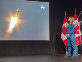 Canadian astronaut Jenni Sidey-Gibbons watches the launch of astronaut David Saint-Jacques for the international space station from Kazakhstan at the Canadian Space Agency headquarters on Dec. 3, 2018, in St-Hubert. The two Albertans graduated Friday, Jan. 10, 2020, from NASA's basic astronaut training, making them part of the next generation of space explorers hoping to return to Earth's satellite and beyond.