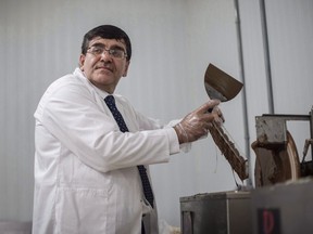 Syrian chocolatier Assam Hadhad puts chocolate into moulds at his newly opened Peace By Chocolate factory in Antigonish, N.S. on Saturday, September 9, 2017. A Nova Scotia chocolate maker who came to Canada as a Syrian refugee will become a Canadian citizen today.
