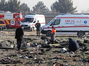 In this file photo taken on Jan. 8, 2020, rescue teams work amid debris after a Ukrainian plane carrying 176 passengers crashed near Imam Khomeini airport in the Iranian capital, Tehran, killing everyone on board.