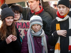 Swedish climate change activist Greta Thunberg, Isabelle Axelsson and German Luisa Neubauer take part in a climate strike protest during the 50th World Economic Forum (WEF) annual meeting in Davos, Switzerland, on Friday, Jan. 24, 2020.