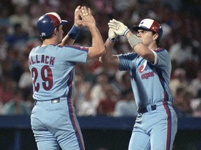 Expos' Larry Walker is greeted by teammate Tim Wallach, left, after Walker's two-run home run in 1990.