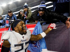 Tennessee Titans running back Derrick Henry (22) celebrates with fans after defeating the New England Patriots at Gillette Stadium.