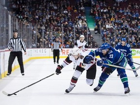 Vancouver Canucks' Alexander Edler checks Phoenix Coyotes' Laurent Dauphin during the first period in Vancouver on Jan. 10, 2019.