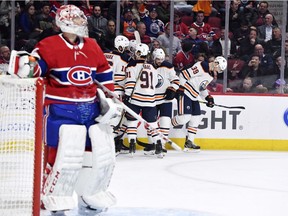Canadiens goalie Carey Price reaches for his water bottle as Edmonton Oilers players celebrate goal by Alex Chiasson during third-period action of NHL game at the Bell Centre in Montreal on Jan 9, 2020.