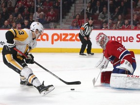 Pittsburgh Penguins' Brandon Tanev shoots against Montreal Canadiens' Carey Price during the first period at the Bell Centre on Saturday, Jan. 4. The interference rule apparently did not apply later in the game, when Price was knocked down and unable to get back to block Tanev’s winning goal in overtime.