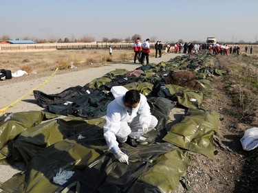 Passengers' dead bodies in plastic bags are pictured at the site where the Ukraine International Airlines plane crashed after take-off from Iran's Imam Khomeini airport, on the outskirts of Tehran, Iran January 8, 2020.