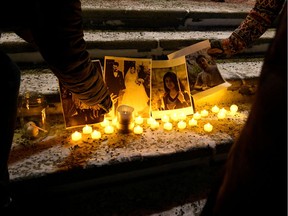 People attend a candlelight vigil at the Alberta legislature building in Edmonton on Jan. 8 in memory of the victims of the crash of a Ukrainian passenger plane in Iran.