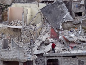 A man stands in an area severely damaged by the January earthquake in Port-au-Prince, Haiti, March 11, 2010.