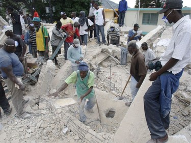 Two days after the earthquake hit, workers search for bodies in the rubble of a building in Port-au-Prince, Haiti, on January 14, 2010.