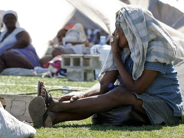 A woman waits in a camp for displaced persons at Parc Dadadou soccer field in Port-au-Prince, Haiti, on January 16, 2010.