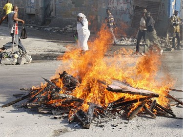 A body recovered from the rubble of the January 10 earthquake is burned in the street in Port-au-Prince, Haiti, on January 18, 2010.