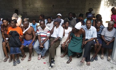 Patients wait for treatment by international volunteers at the Family Health Ministries clinic in Cité Soleil, Port-au-Prince, on January 19, 2009, seven days after the 7-magnitude earthquake hit the country.