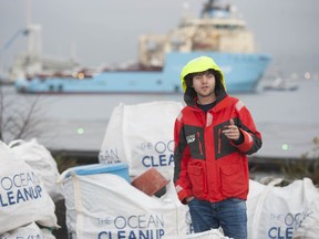 The Ocean Cleanup CEO Boyan Slat speaks to the media in Vancouver on Dec. 12, 2019, about the efforts made to clean plastic debris from the oceans. Results of that clean-up fill the white bags around him.