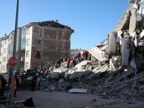 Search and rescue teams work on a collapsed building after an earthquake in Elazig, Turkey, January 25, 2020.