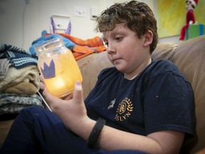 Hugh Edwards, 11, with the Mason jar he decorated in memory of his late step-mother in the camp's popular waterfront luminary ceremony.