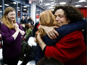 Sue Montgomery gets a warm greeting from members of an over-capacity crowd at Monday's borough council meeting.