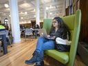 Rubana Choudhry relaxes as she studies in the newly renovated John Abbott College library on Monday.  The library had been closed for nearly three years while undergoing its transformation.