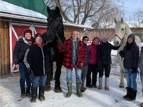 AHT Rescue staff pose with two ex-calèche horses, Maximus and Freddy from Lucky Luc's, the first taken in since Montreal's ban came into effect last month.