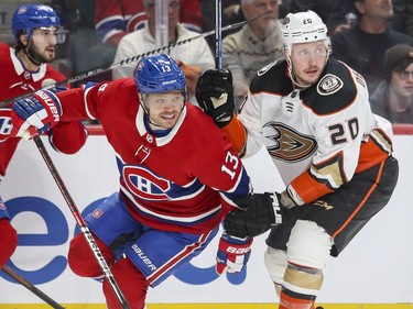 Montreal Canadiens Max Domi fights through the check by Anaheim Ducks Nicolas Deslauriers during first period of National Hockey League game in Montreal Thursday February 6, 2020.