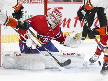 MONTREAL, QUE.: FEBRUARY  6, 2020 -- Montreal Canadiens Carey Price looks through sticks and skates for the puck during second period of National Hockey League game against the Anaheim Ducks in Montreal Thursday February 6, 2020. (John Mahoney / MONTREAL GAZETTE) ORG XMIT: 63901 - 6375