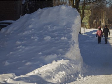 Snow is piled high on Strathearn Ave. in Montreal West on Saturday, Feb. 8, 2020. Montreal received the biggest snowfall of the winter season Friday.