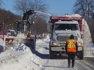 A crew clears snow on Broughton Road in Montreal West Feb. 8, 2020.