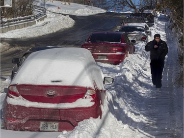 Anmonique James zips up against the cold on des Érables St. in Lachine on Saturday, Feb. 8, 2020.