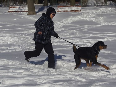 Sergio Ardila and his dog Coco have some snowy fun in N.D.G. on Saturday, Feb. 8, 2020.
