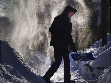 Marco Hedou heads for another shovelful of snow on Monkland Ave. in Montreal Feb. 8, 2020.