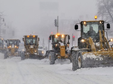 A convoy of snowplows head south on Park Ave. during a snow storm in Montreal on  Friday, Feb. 7, 2020.