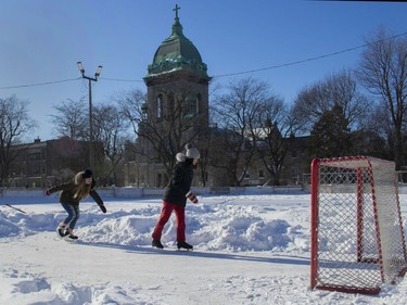 Lizzie Hillebrand (left) and Tania McCarty cleared snow from a part of a snow-covered rink in N.D.G. so they could skate on Saturday, Feb. 8, 2020.